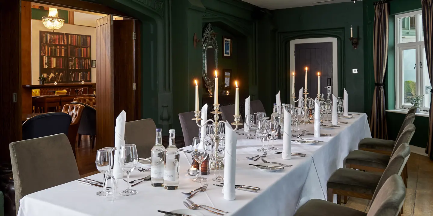 A dining room featuring a spacious table and chairs.