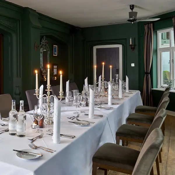 A dining room featuring a spacious table and chairs.