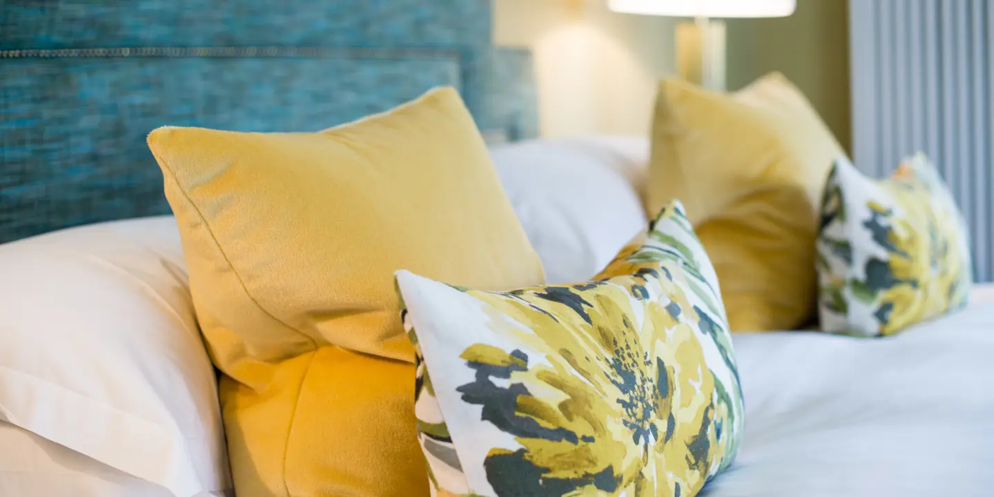 A bed adorned with multiple pillows.