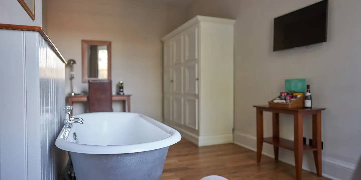 Bathroom with a bathtub and chair.