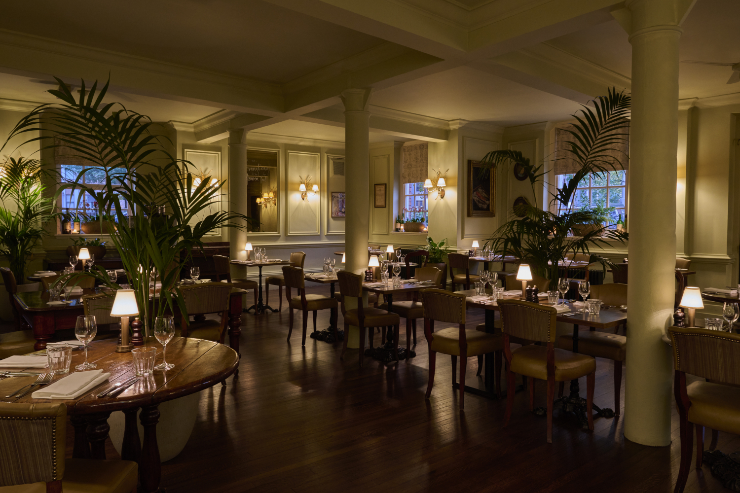 A lowly lit dining hall with a rustic wooden theme