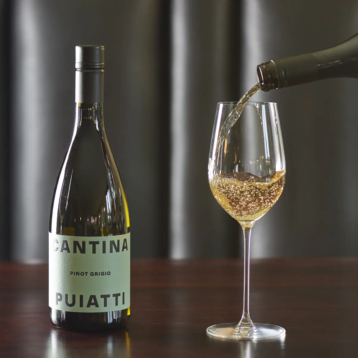 Pouring white wine into glass