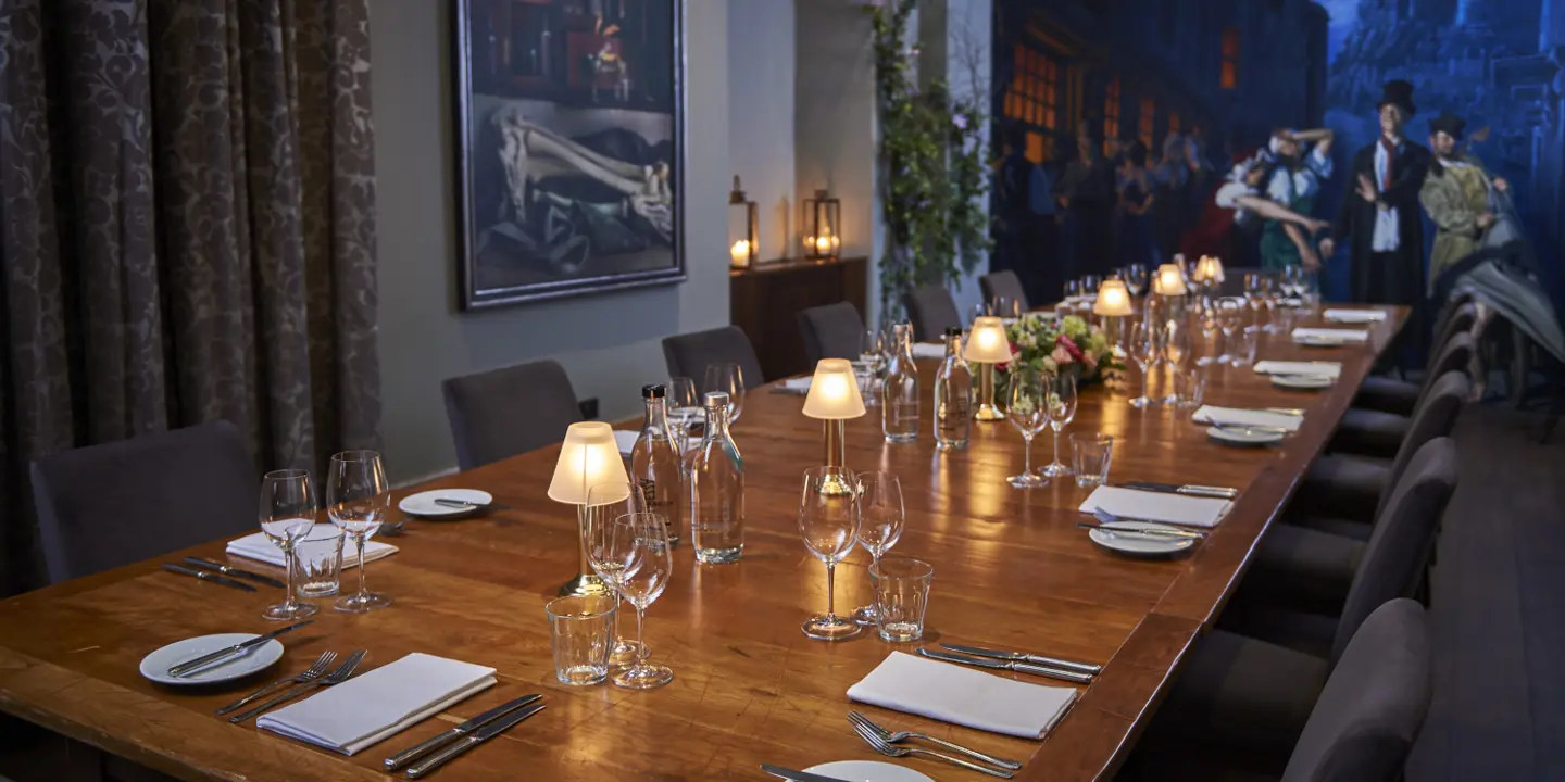 A beautifully arranged table adorned with sparkling wine glasses and elegant silverware.