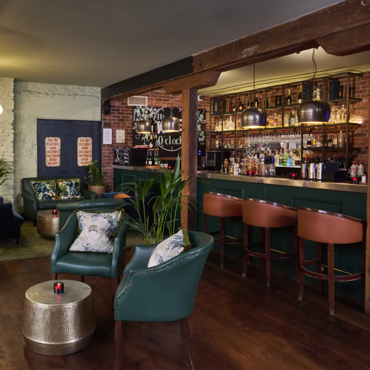 A bar with a range of seating and wooden theme