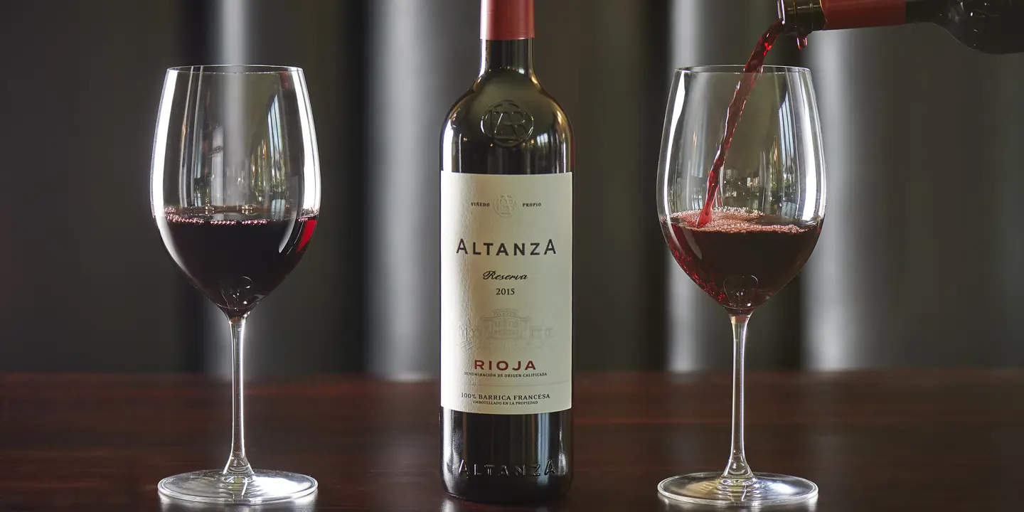 Red wine is poured into a glass