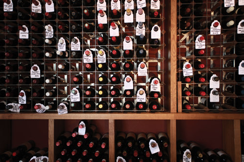 Wine Cellar wall with selection of bottles all labelled
