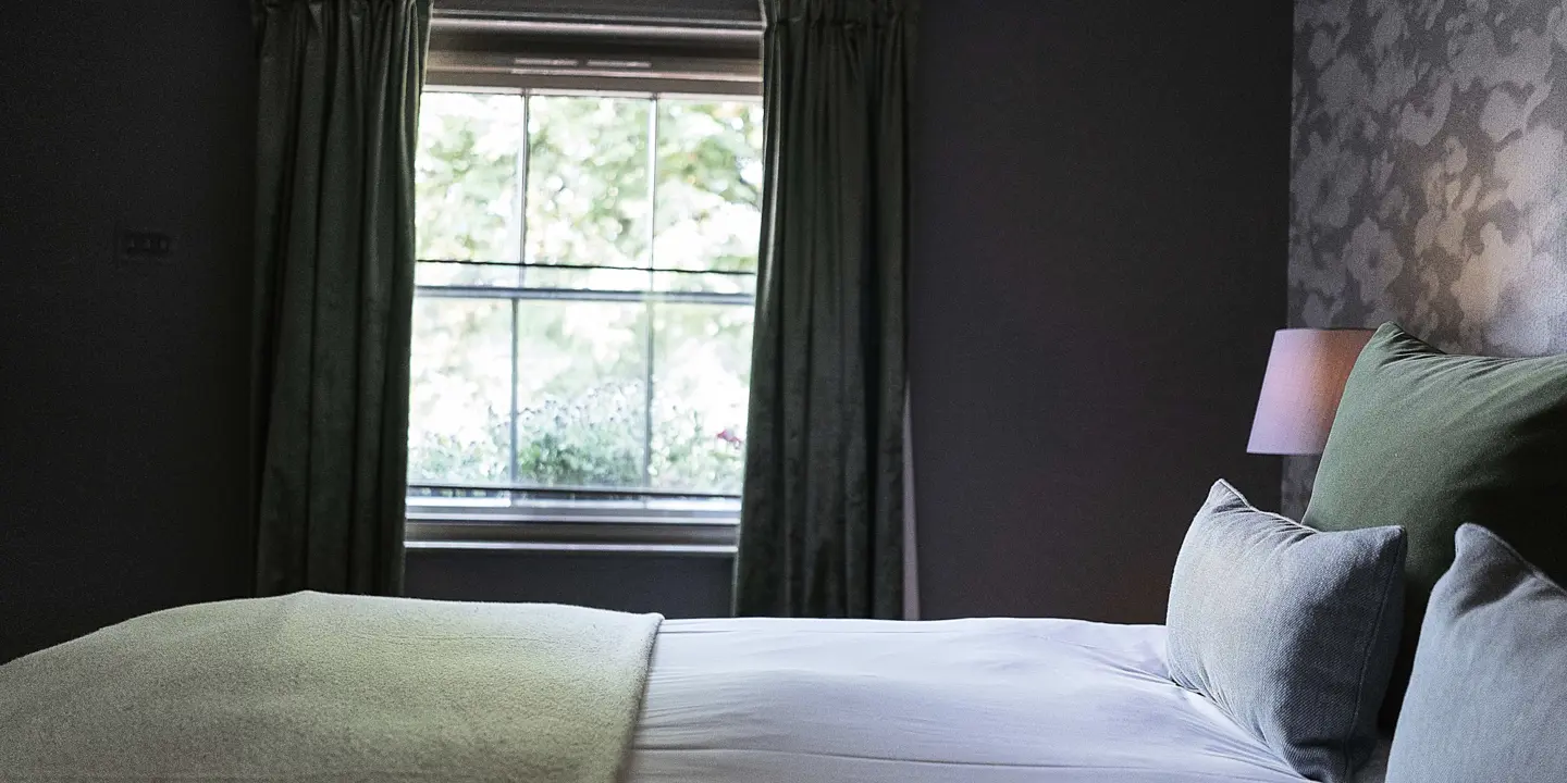 Spacious bedroom featuring a generously sized bed and a window.