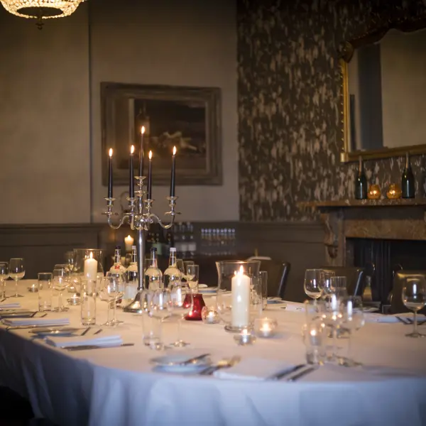 Table set for a formal dinner with candles.