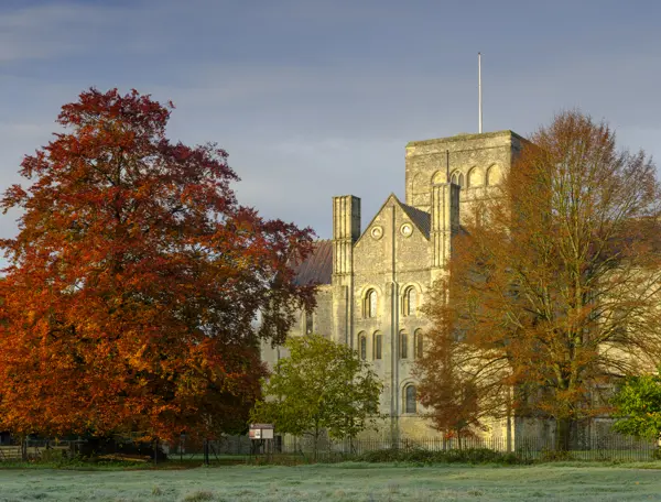 An imposing building featuring a clock tower atop.