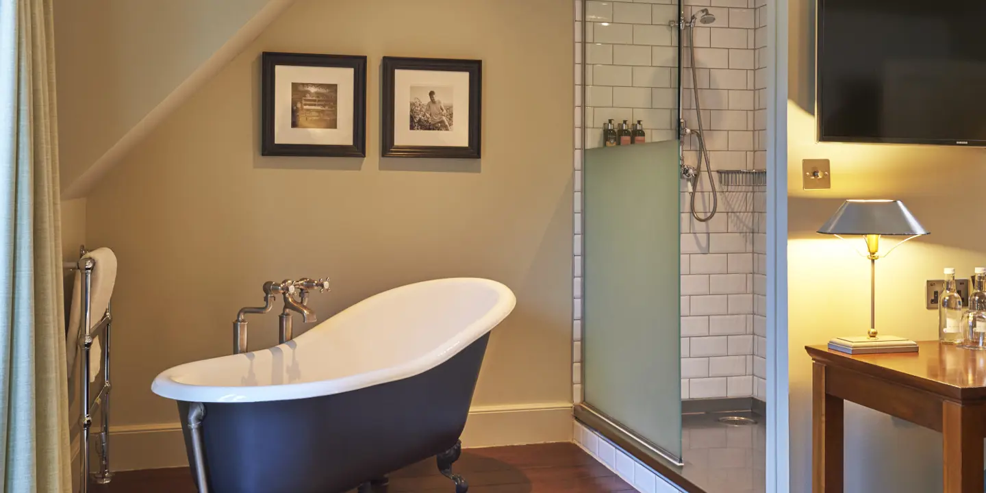 A bathroom with a large roll top bath