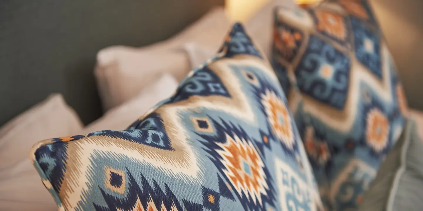 Two pillows placed neatly on a bed.