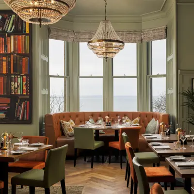 A spacious dining room filled with numerous tables and chairs.