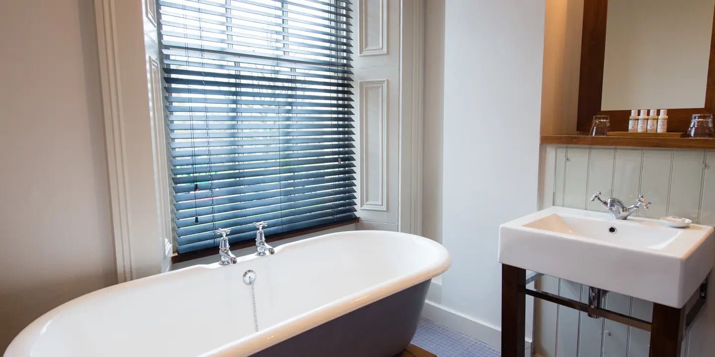 Bathroom with a spacious bath, a sink and mirror