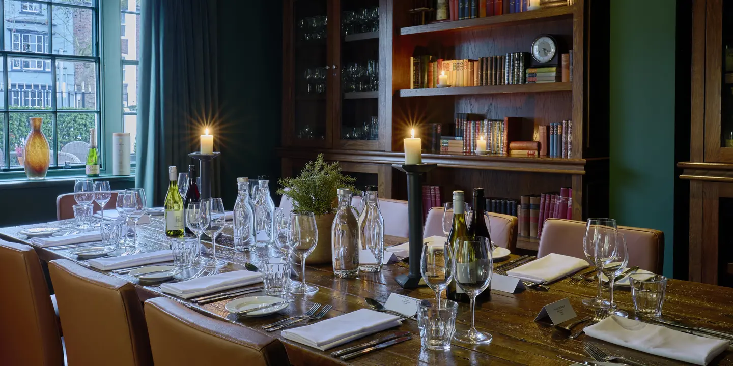 A beautifully arranged dining table with elegantly set place settings.