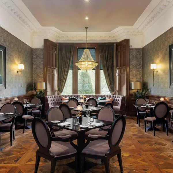 Dining room featuring elegant chairs and a stunning chandelier.