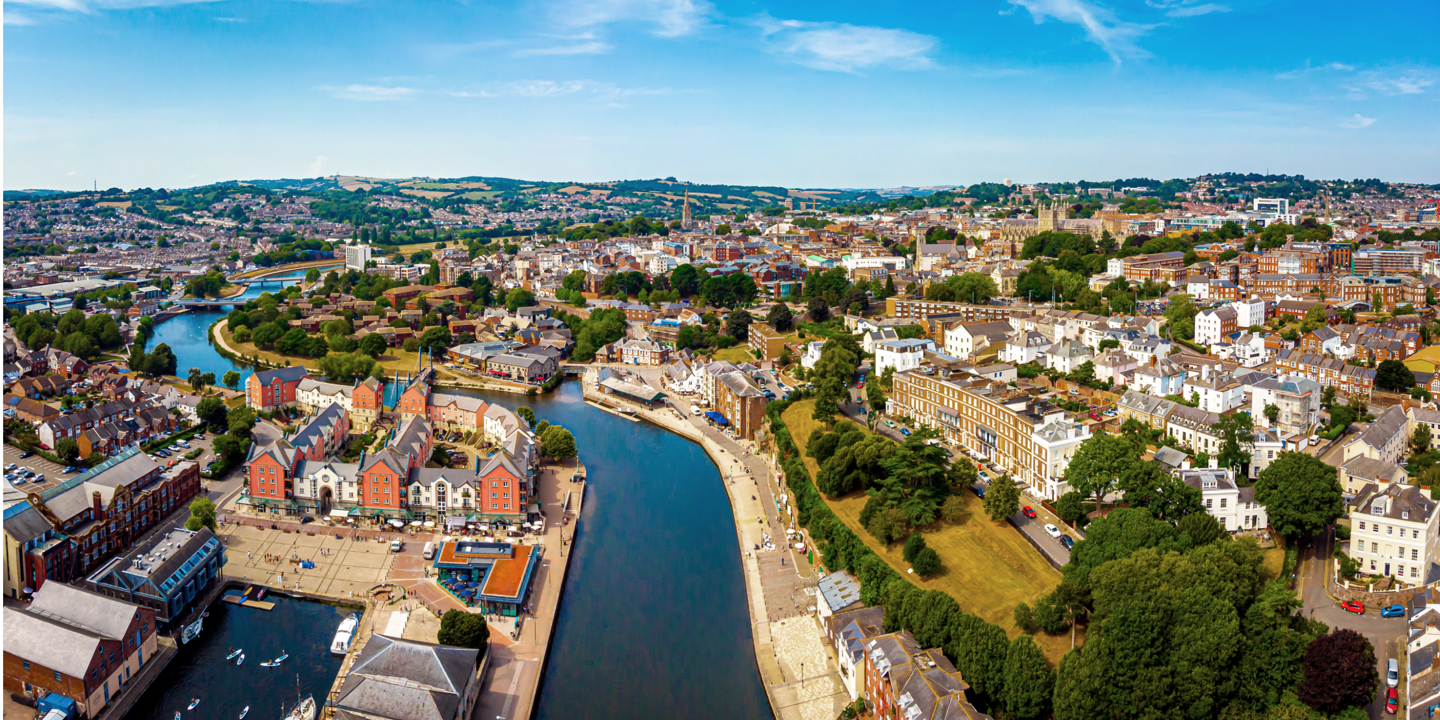 A panoramic view of a cityscape with a meandering river flowing through its midst.