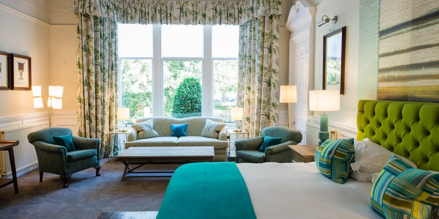 A bed positioned in a bedroom adjacent to a window.